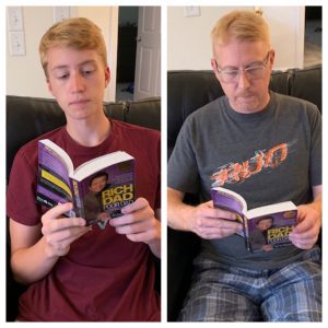 Liam and his dad, Andy, enjoying reading Rich Dad Poor Dad for MFF Book Club